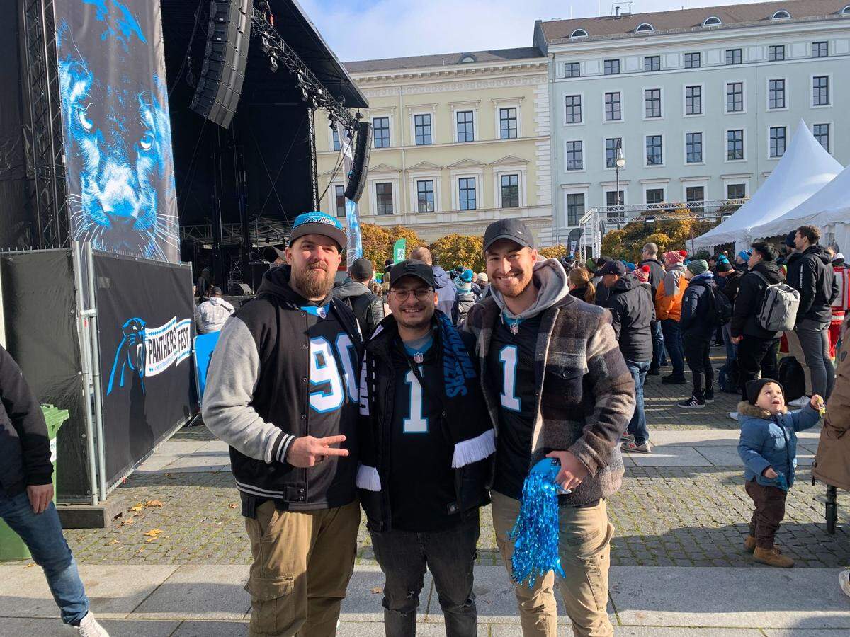 Germany-based Carolina Panthers fans Tobias Dorf (left), Marcel Travaci (middle) and Yannick Roob (right) pose for a picture during the team’s Fan Fest in Munich, Germany on Saturday, Nov. 9, 2024.