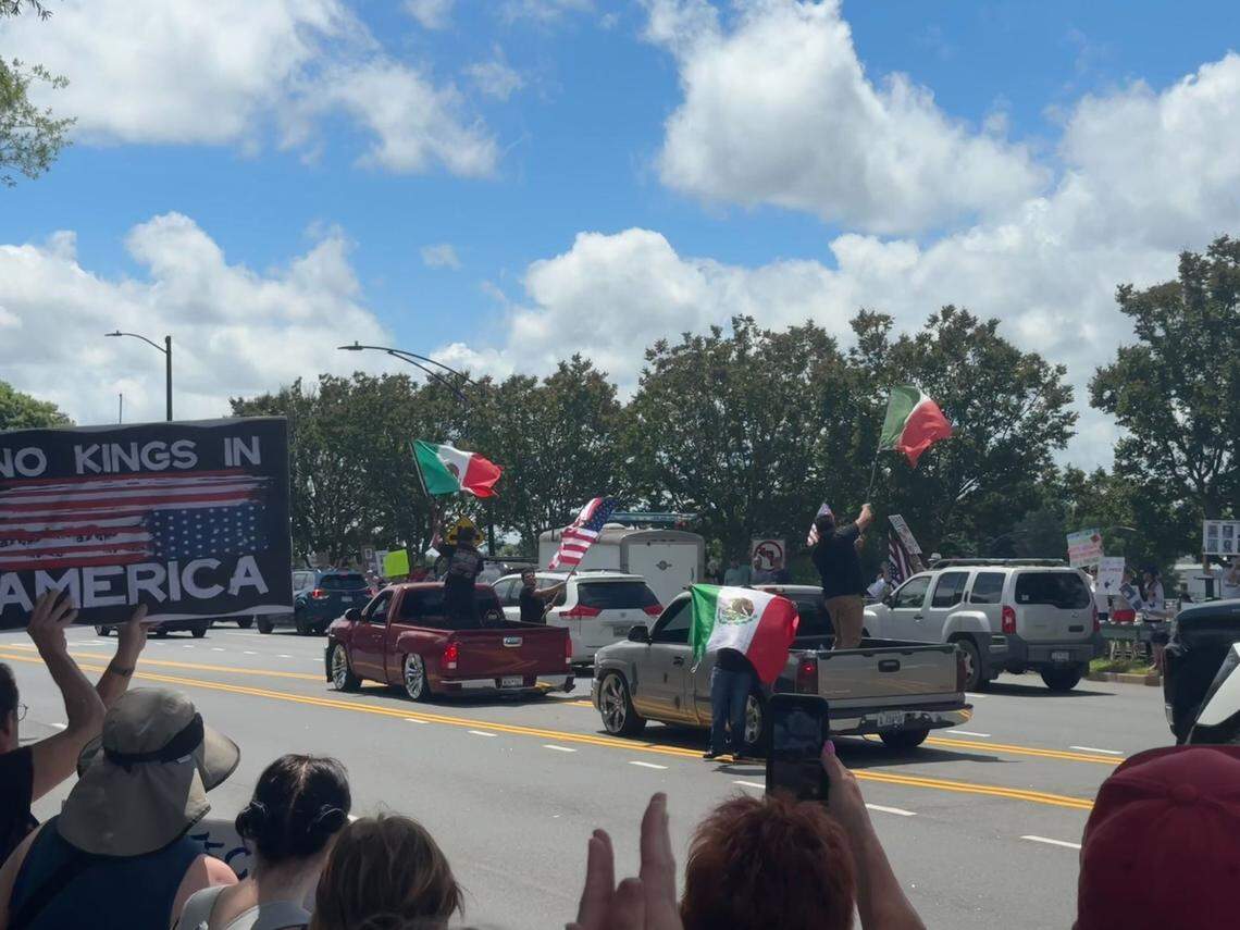Two trucks waving Mexican&nbsp;and American&nbsp;flags momentarily blocked a left turn lane in Rock Hill at the “No Kings” rally. Some in the crowd cheered, while there were a couple apprehensive pleas that they not block traffic and risk police intervention.
