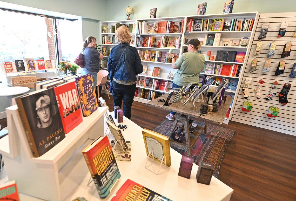Shoppers mingle in a corner at Troubadour Booksellers, a new independent book store that Scott Tynes-Miller opened.