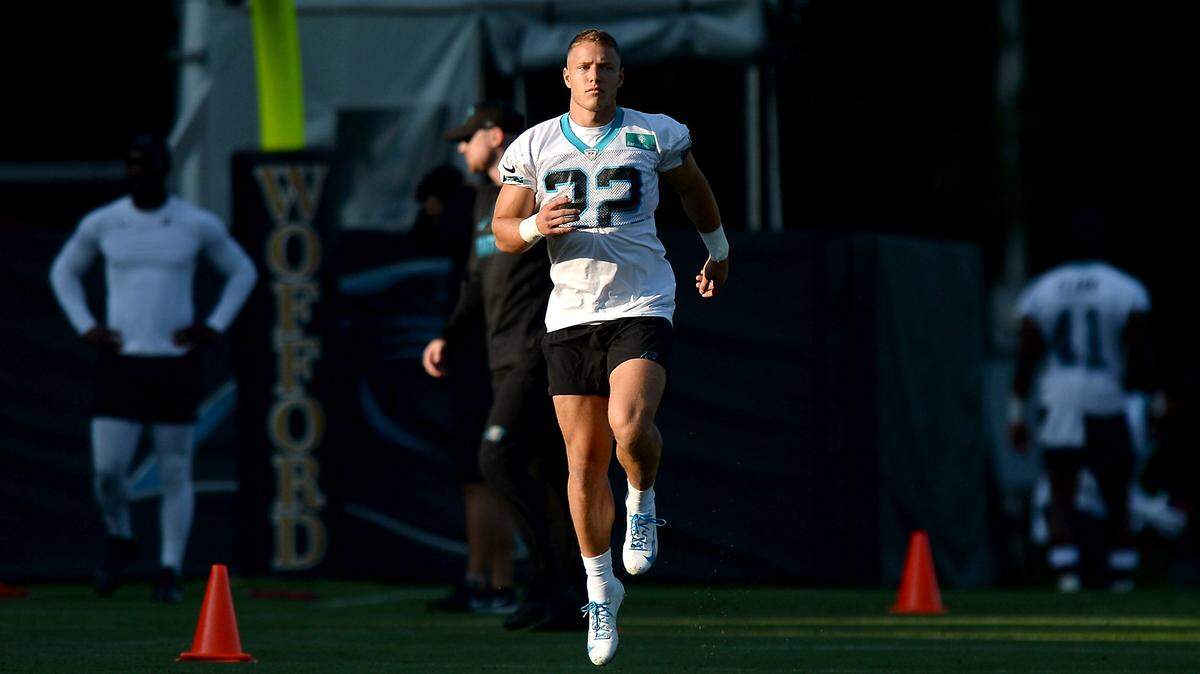 Carolina Panthers running back Christian McCaffrey, shown loosening up in 2021, is healthy again. But he has missed 23 of the Panthers’ past 33 games due to various injuries.