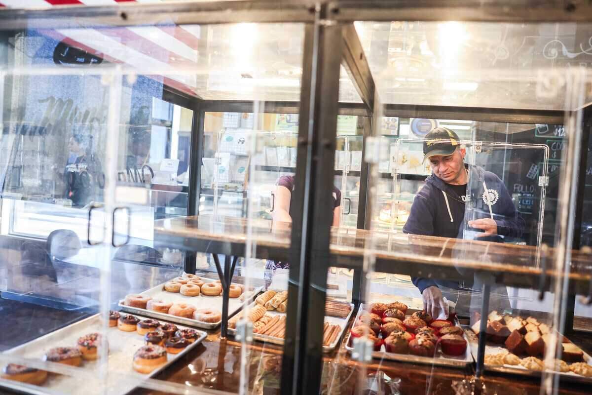 Manolo’s Bakery owner Manolo Betancur fills an order.