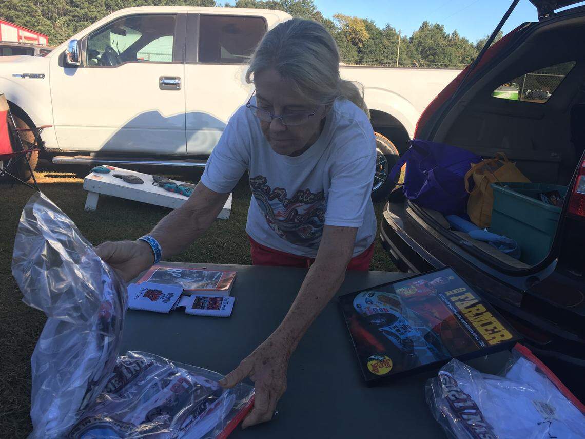 Red Farmer’s wife, Judy Goodwin, sets up a stand for racing fans to purchase Farmer’s memorabilia before a dirt track race at the Talladega Short Track in Alabama. Goodwin and Farmer met through racing and were married on Christmas Day.