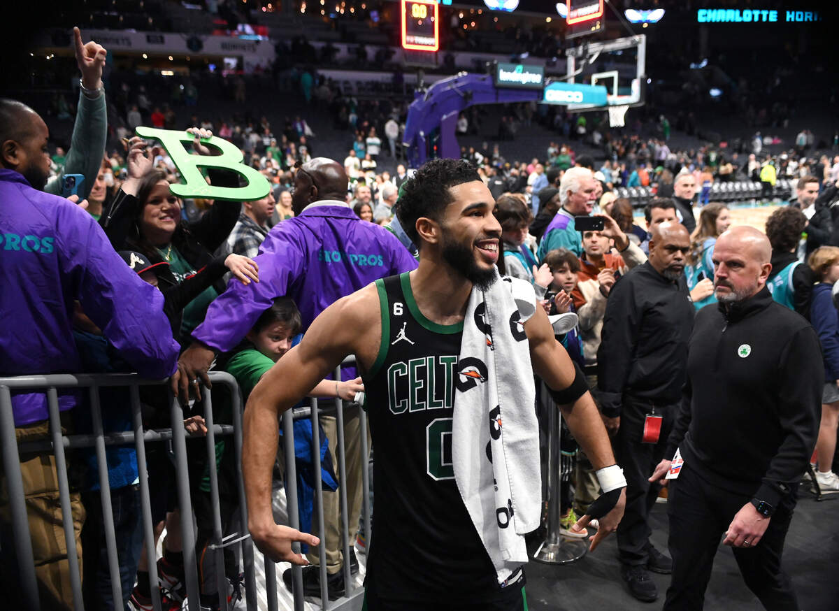 Boston Celtics forward Jayson Tatum, center, smiles back at the fans as he exits the court at Spectrum Center in Charlotte, NC on Monday, January 16, 2023. Tatum scored 51 points in the Celtics’ 130-118 win over the Charlotte Hornets.