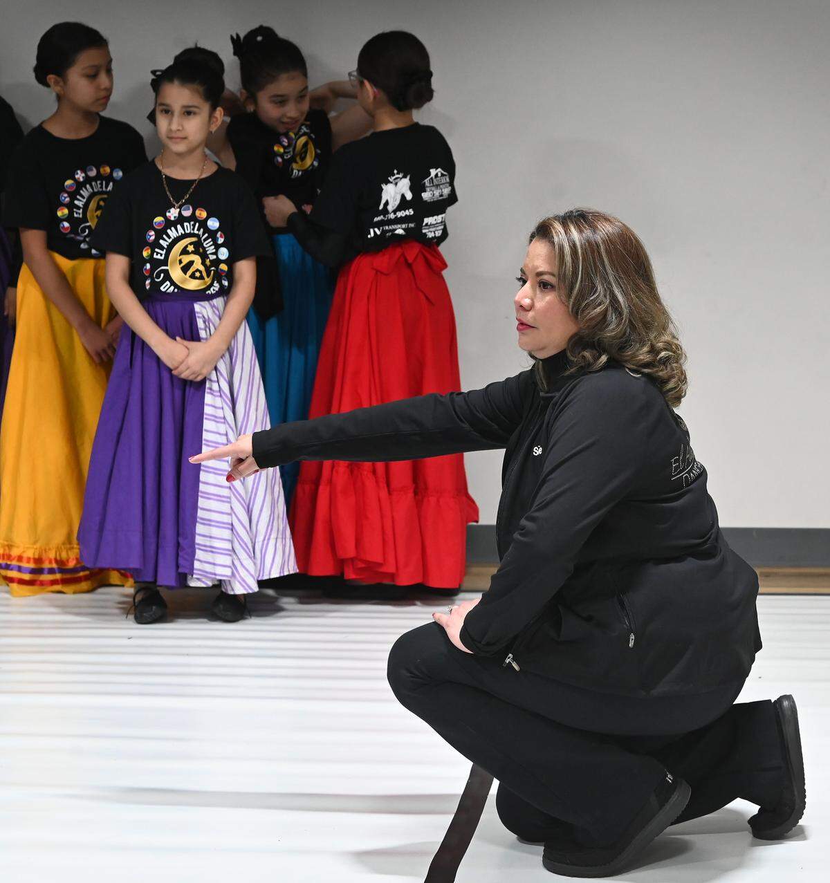 El Alma de la Luna co-director Selene Pringle gives instructions to dance members during rehearsal on Wednesday, February 25, 2026. The Latin dance academy celebrates the richness of Latin culture through the art of dance. Members of the troupe not only learn to move to the rhythm of the music but also immerse themselves in an experience that fosters a connection with their cultural heritage, the development of social skills and creative expression. 