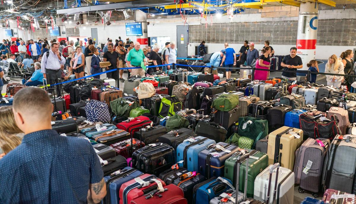 Hundreds of passenger wait to get their luggage inside the Charlotte Douglas International Airport on August 5, 2024. Hurricane Debby caused about 300 flight delays or cancellations as of noon Monday.