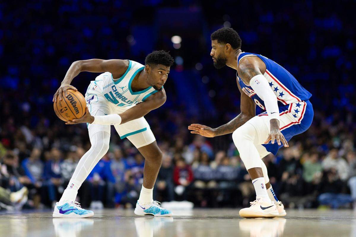 Nov 10, 2024; Philadelphia, Pennsylvania, USA; Charlotte Hornets forward Brandon Miller (24) controls the ball against Philadelphia 76ers forward Paul George (8) during the second quarter at Wells Fargo Center. Mandatory Credit: Bill Streicher-Imagn Images
