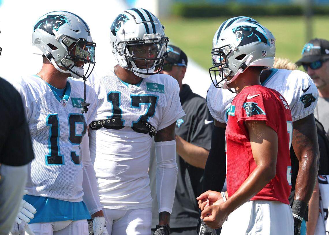 Carolina Panthers quarterback Bryce Young, right, talks to wide receivers Adam Thielen (19) and DJ Chark (17) prior to a drill on Aug. 9th. Young and Chark have shown a nice connection throughout training camp.