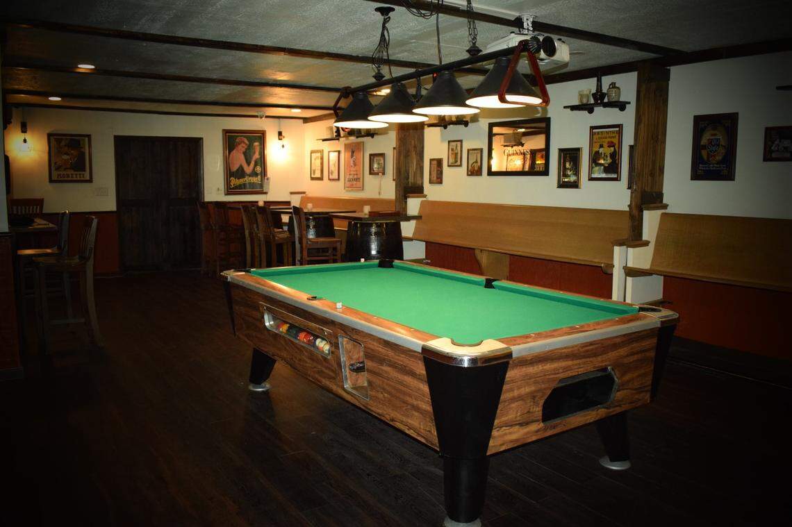 Matthews Social House includes a pool table and refurbished church pews.