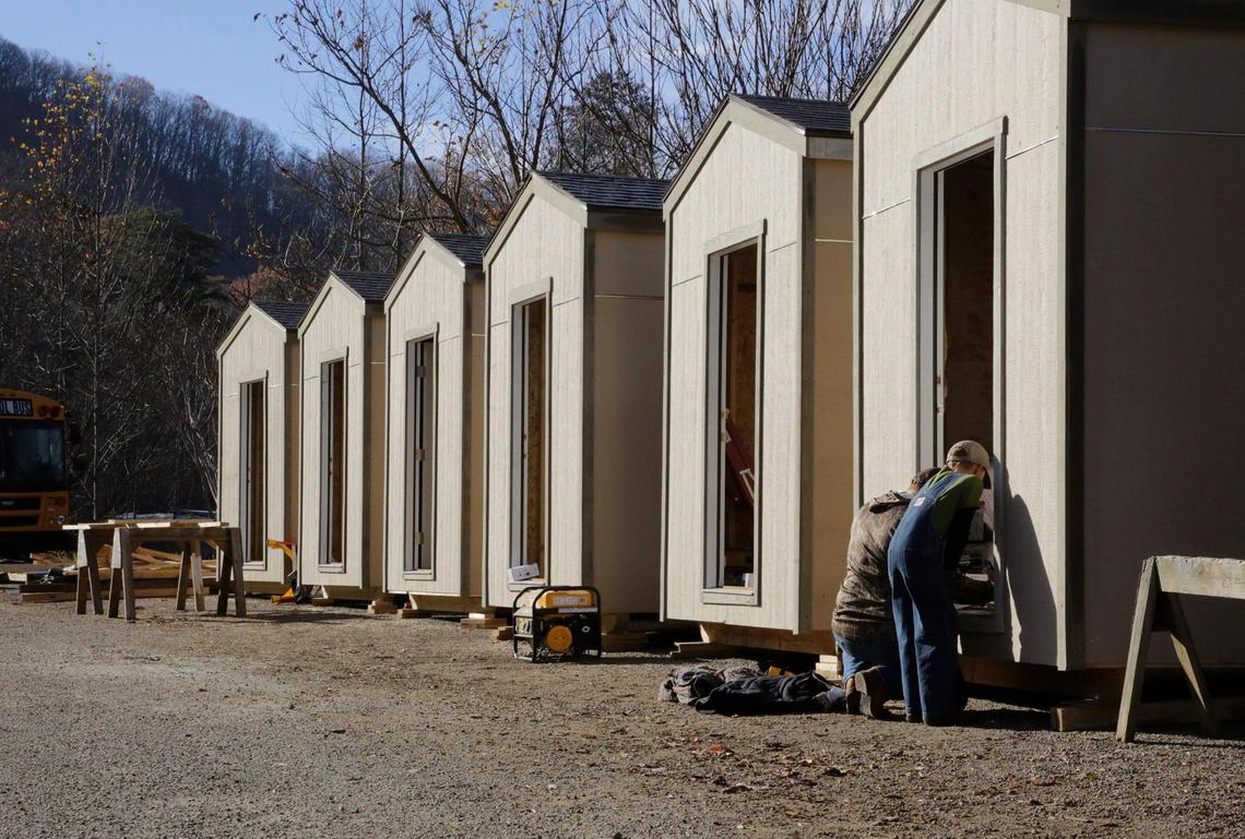Kevin Woody and his 10-year old son Hampton Woody of Dawsonville, Ga., work on a tiny home the last week of November at the Cabins 4 Christ work site near Asheville.