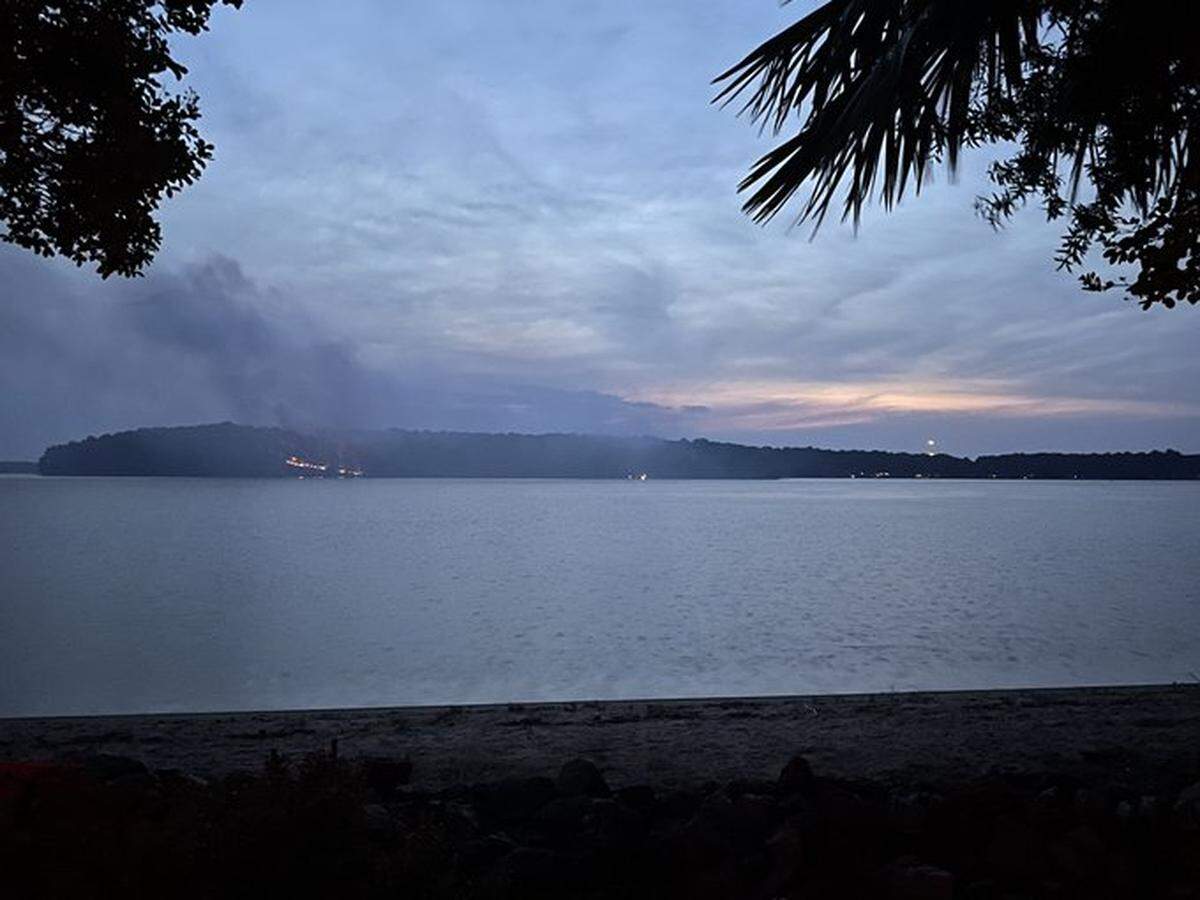 Smoke billows from a fire on Lynch Island on Lake Norman Tuesday morning, June 14, 2022. The cause is unknown, fire officials said.