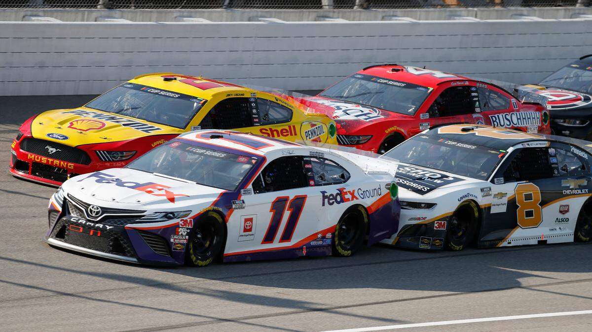 Denny Hamlin (11), Joey Logano (22), Kevin Harvick (4) and Tyler Reddick (8) compete during a NASCAR Cup Series auto race at Michigan International Speedway in Brooklyn, Mich., Saturday, Aug. 8, 2020. (AP Photo/Paul Sancya)