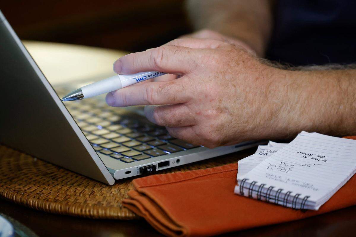Dan Johnson works at his laptop in his home in the Plaza Shamrock neighborhood of Charlotte.