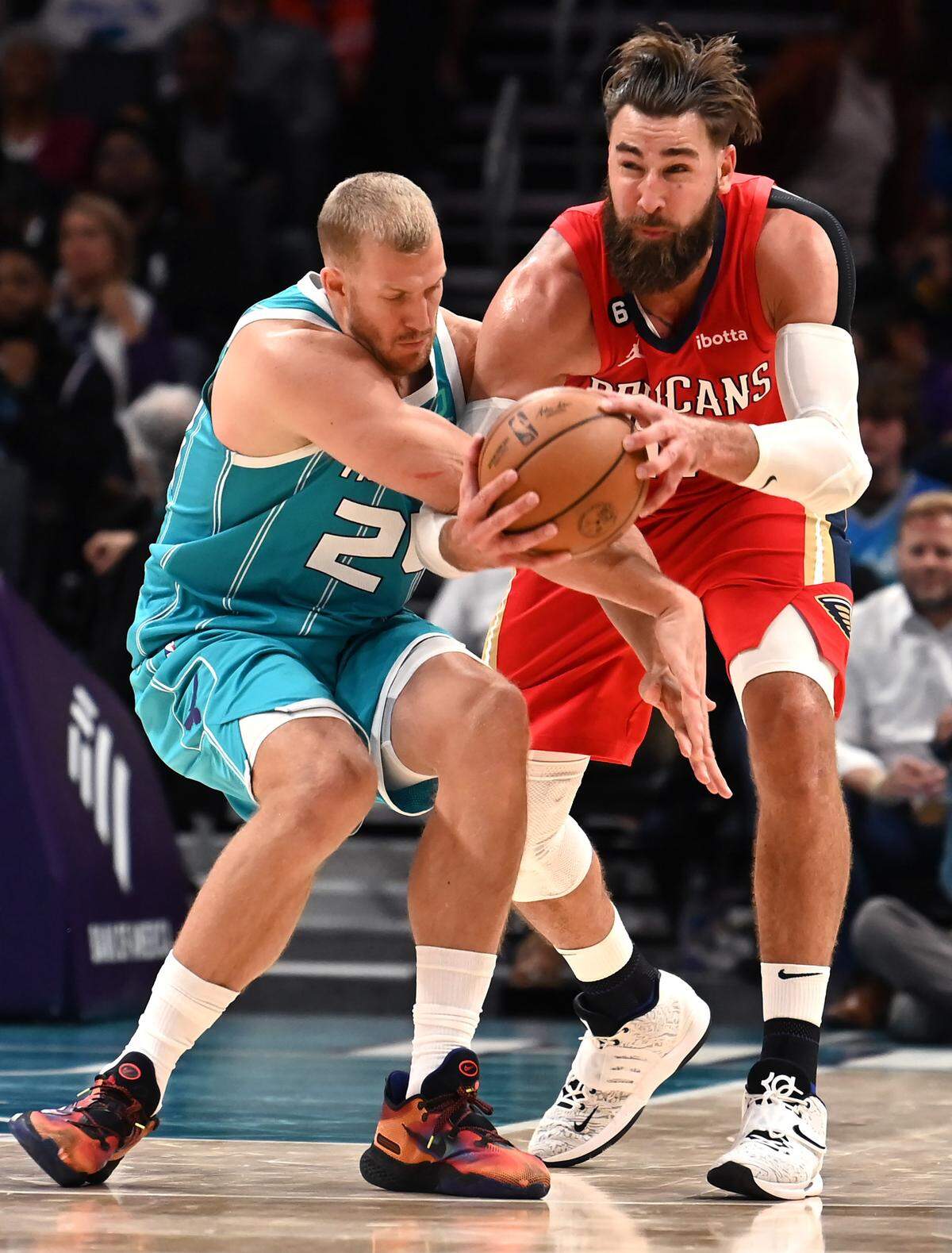 Charlotte Hornets center Mason Plumlee, left, fights for control of a loose ball with New Orleans Pelicans center Jonas Valanciunas during second-half action on Friday, October 21, 2022 at Spectrum Center in Charlotte, NC. Valanciunas finished with 30 points and 17 rebounds in New Orleans’ 124-112 win before a sellout crowd of 19,287 at the Spectrum Center.