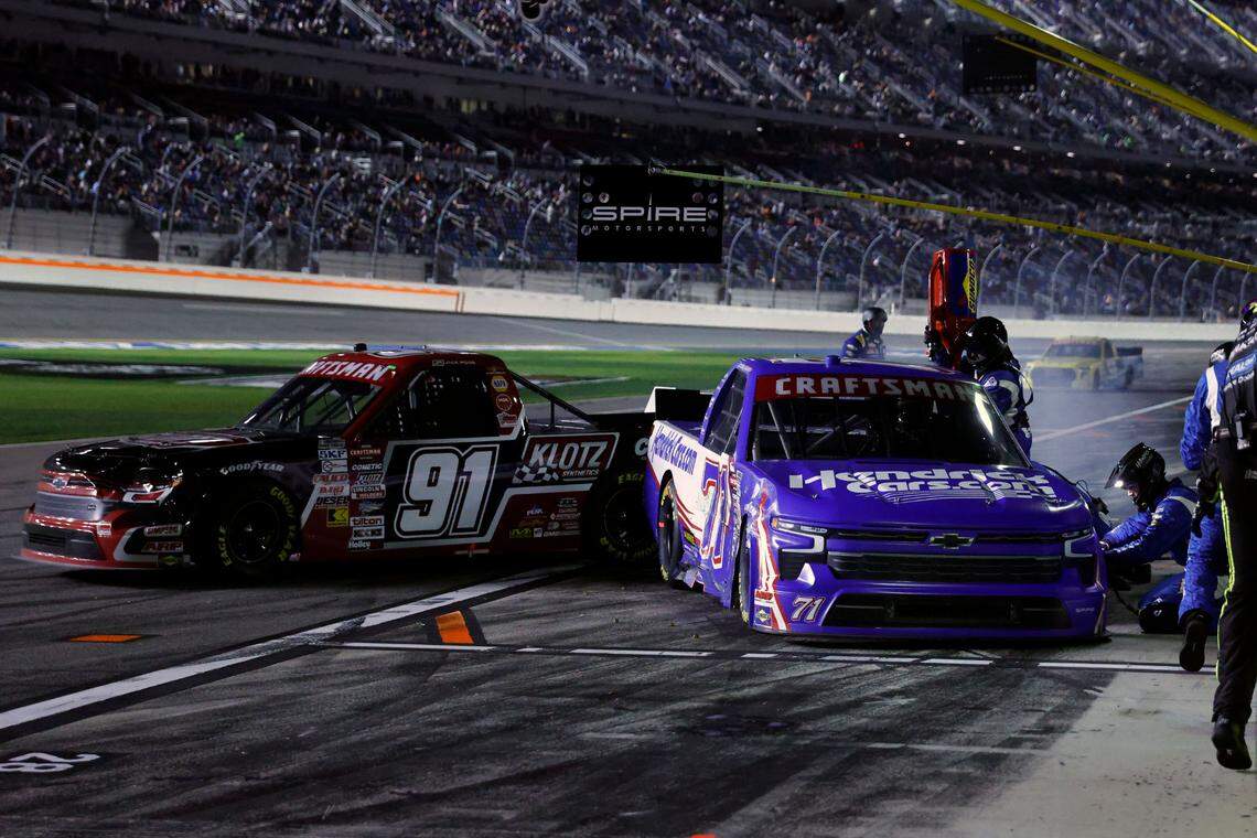 Feb 16, 2024; Daytona Beach, Florida, USA; NASCAR Truck Series driver Rajah Caruth (71) and driver Jack Wood (91) collide on pit road during the Fresh From Florida 250 at Daytona International Speedway. Mandatory Credit: Peter Casey-USA TODAY Sports