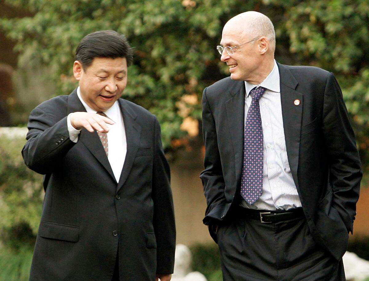 U.S. Treasury Secretary Henry Paulson, right, and Xi Jinping, then the Zhejiang Province Communist Party Secretary, left, speak on Sept. 19, 2006 in Hangzhou, China.