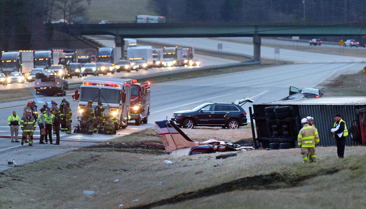 Emergency personnel work at the scene where a twin-engine Beechcraft Barron plane crashed into a tractor-trailer on southbound Interstate 85 near the Davidson County Airport in Lexington in February. The pilot, Raymond John Ackley of Charlotte was killed.