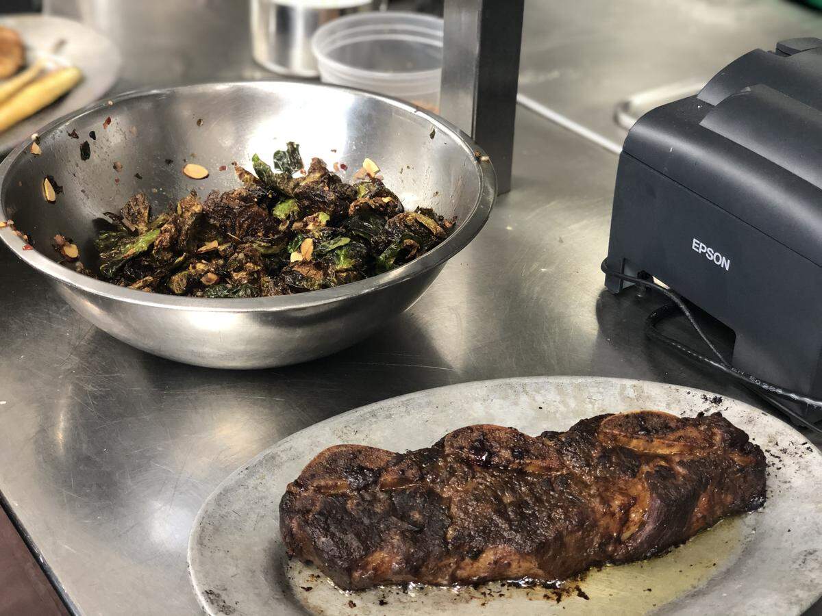 Short ribs and Brussels sprouts are ready for plating at the Charlotte City Club.