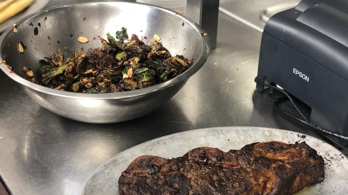 Short ribs and Brussels sprouts are ready for plating at the Charlotte City Club.