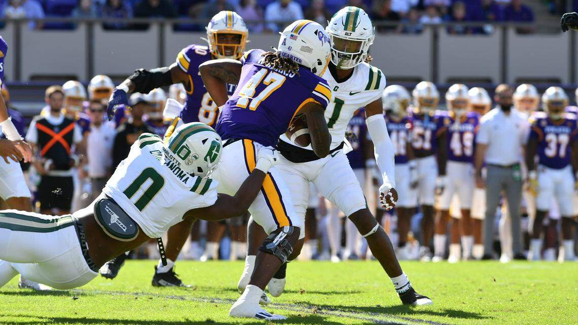 Charlotte 49ers defensive lineman Eyabi Okie-Anoma drags down ECU’s Rahjai Harris during their game in Greenville, NC, on Saturday, Oct. 21.