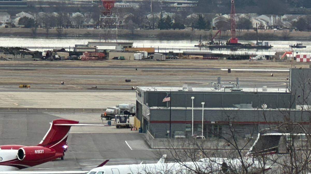 A crane sits on the Potomac River near Reagan National Airport in Arlington, Virginia, removing wreckage of an American Airlines flight that crashed with a helicopter on Wednesday, Jan. 29, 2025.