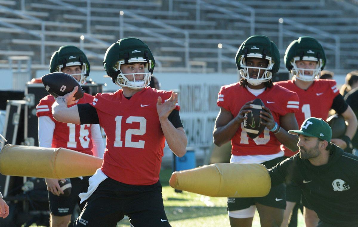 Charlotte 49ers quarterbacks Tanner Bushee (16), Grayson Loftis (12, throwing), Conner Harrell (15) and Zach Wilcke (1) during spring workouts.