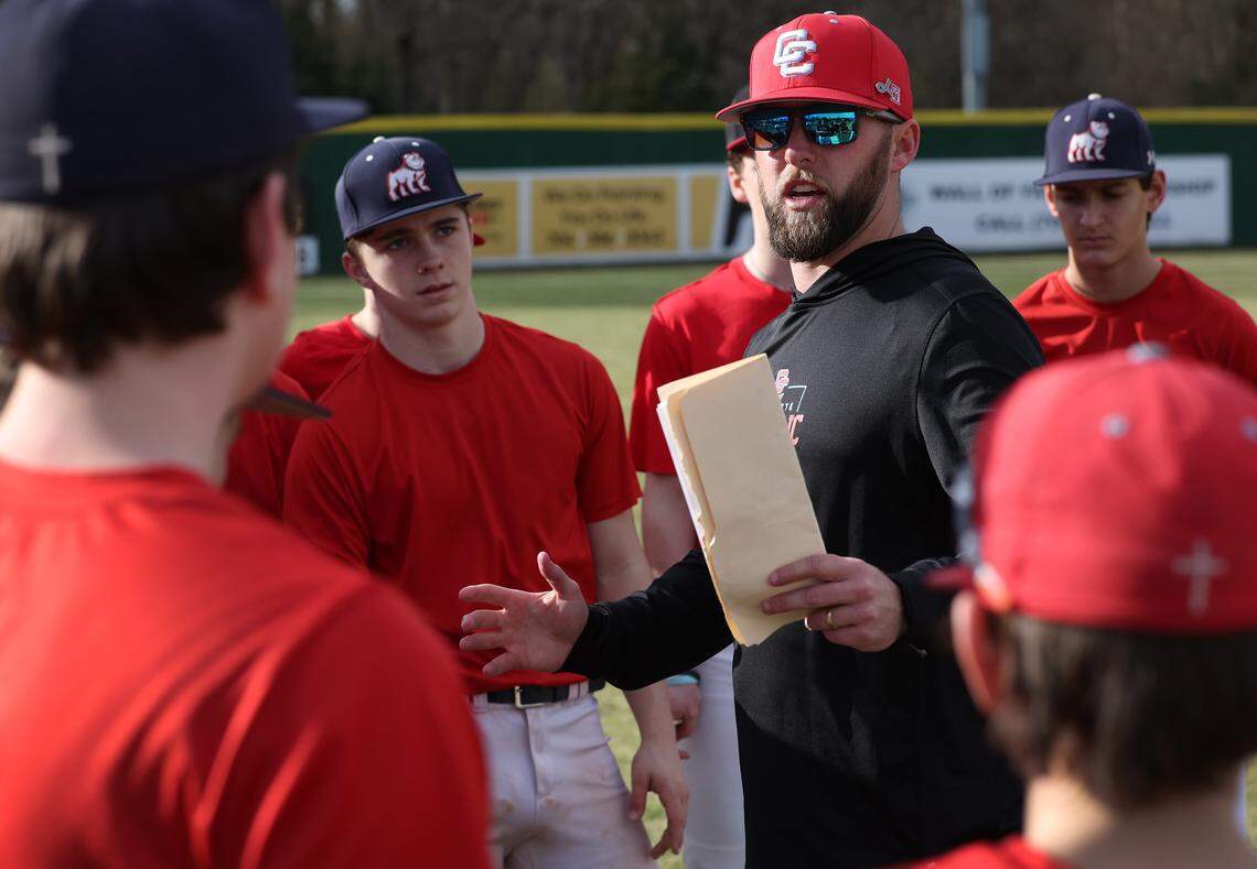 Charlotte Catholic Cougars head baseball coach Eddie Hull, center, speaks to his players during practice on Feb. 13, 2026. Charlotte Catholic is No. 1 in The Observer’s Sweet 16 rankings.