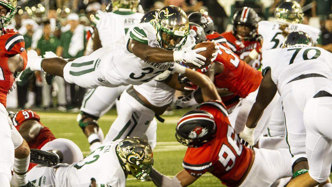 Charlotte's Benny LeMay, center, dives into the end zone for the 49ers' first touchdown against Gardner-Webb during the season opener for new coach Will Healy's team. Charlotte won 49-28.