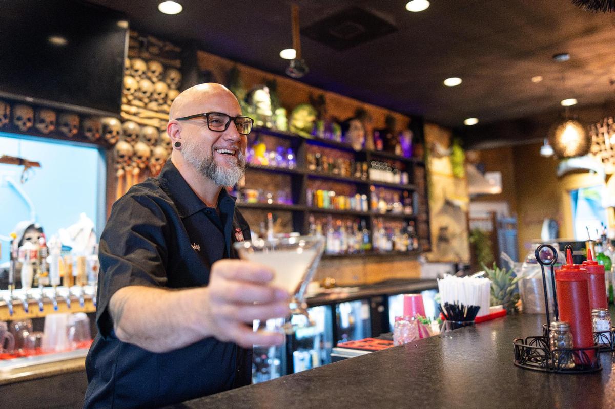 Andy Cauble serves up a cocktail at Pinky’s Westside Grill’s Huntersville location, one of two he co-owns in the area.
