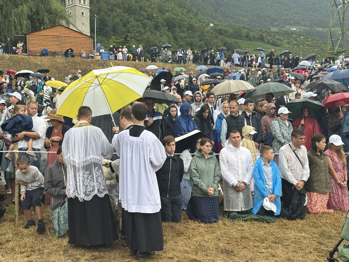 Catholics kneel in the mud to recieve Communion in Switzerland on Wednesday, where the Society of St. Pius X consecrated four new bishops against the pope’s orders.