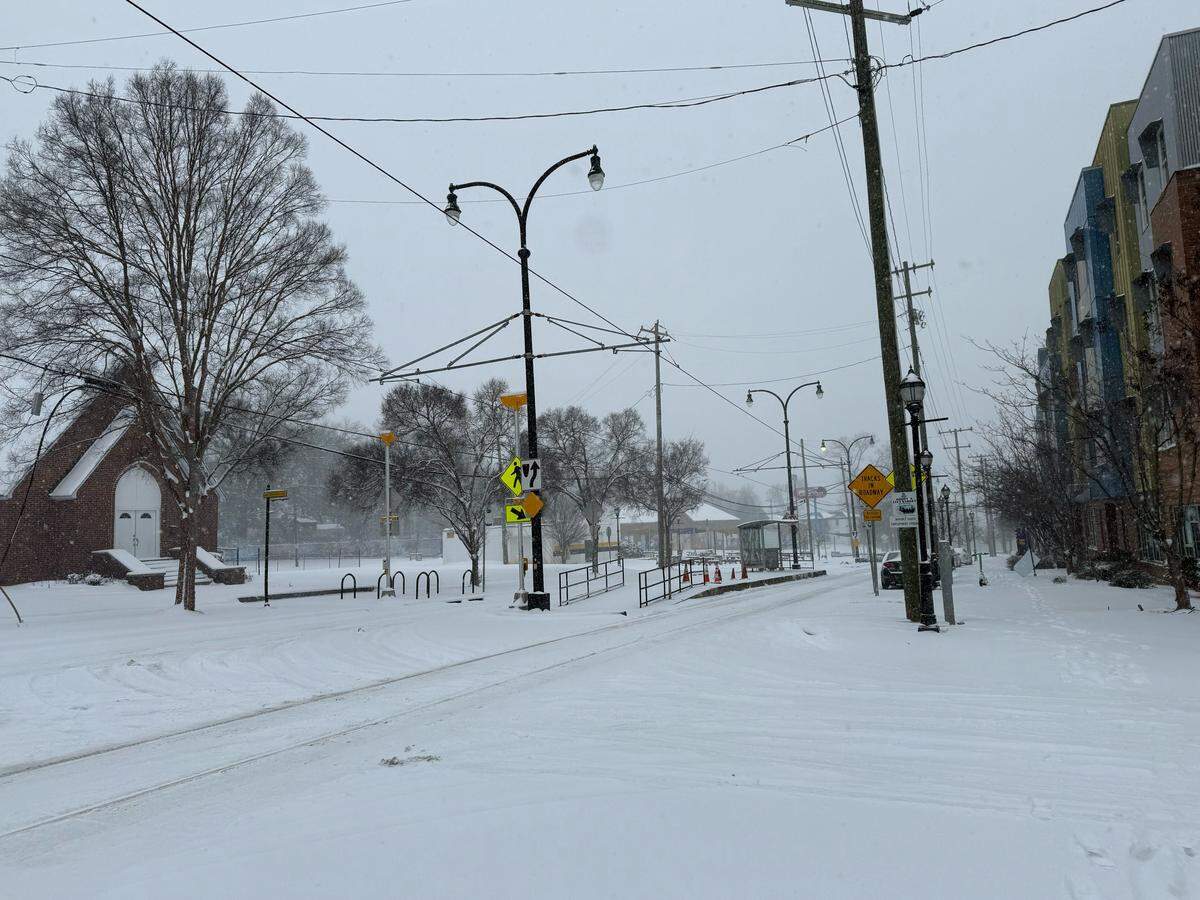 Snow continues to fall over in a neighborhood near John C. Smith University in Charlotte on Saturday, January 31, 2026.