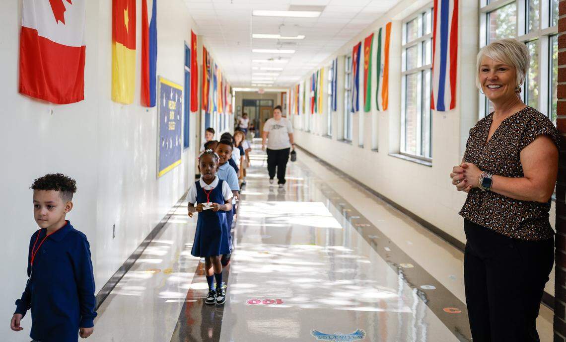 Idlewild Elementary School Principal Trish Stewart smiles at students as they walk down the hall during the first day of school on Monday, August 26, 2024.