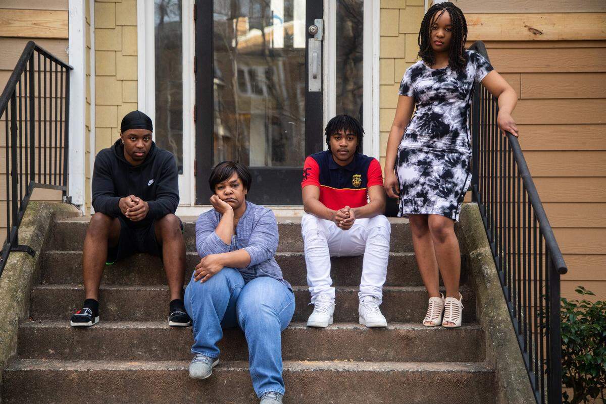 Zsa Zsa Conyers, 51, poses outside her apartment with her children, Jaheim McKenney, 17, left, Jalen McKenney, 16, and Tionna McKenney, 21, right, in Greensboro. Conyers lost her Burlington home about six years ago after Wells Fargo denied a request to lower her mortgage payments.