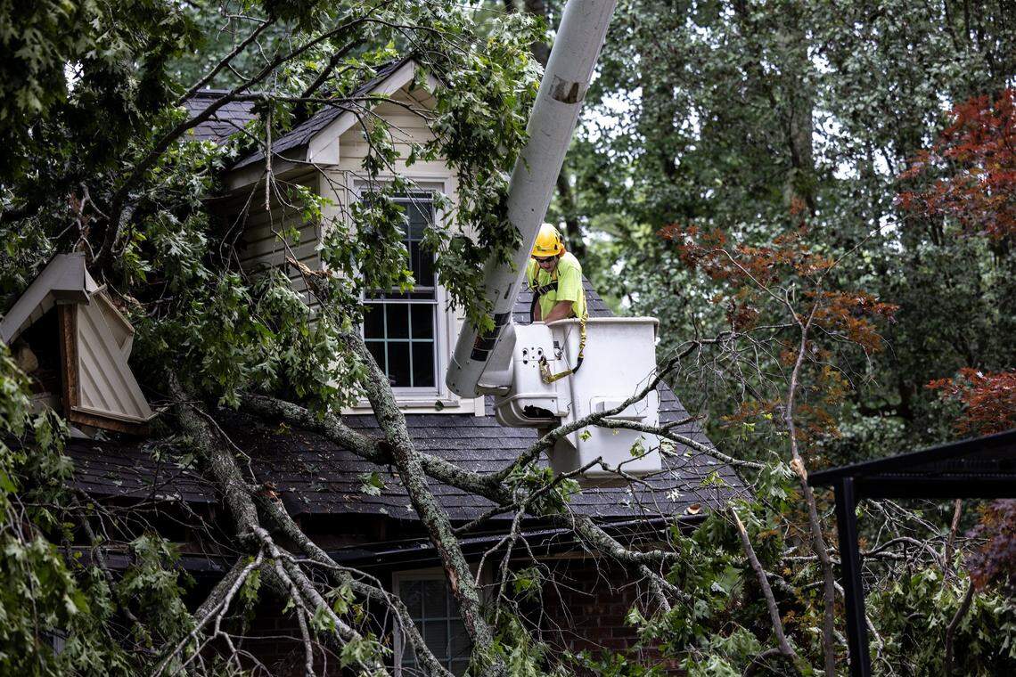 A crew works to clear tornado damage from Scottie Wolds’ home in Harrisburg, NC, on Tuesday, May 24, 2022.