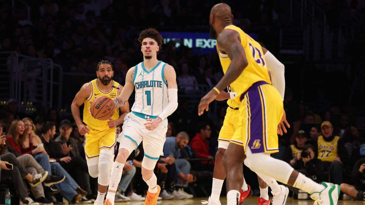 Charlotte Hornets guard LaMelo Ball (1) dribbles against Los Angeles Lakers forward LeBron James (23) during the third quarter at Crypto.com Arena.