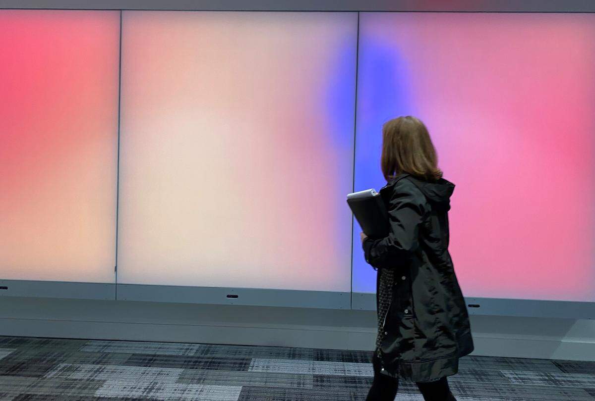 An interactive art piece in the main lobby of the Sarah Belk Gambrell Center for the Arts and Civic Engagement changes colors as visitors pass by. It also changes colors in response to loud sounds.