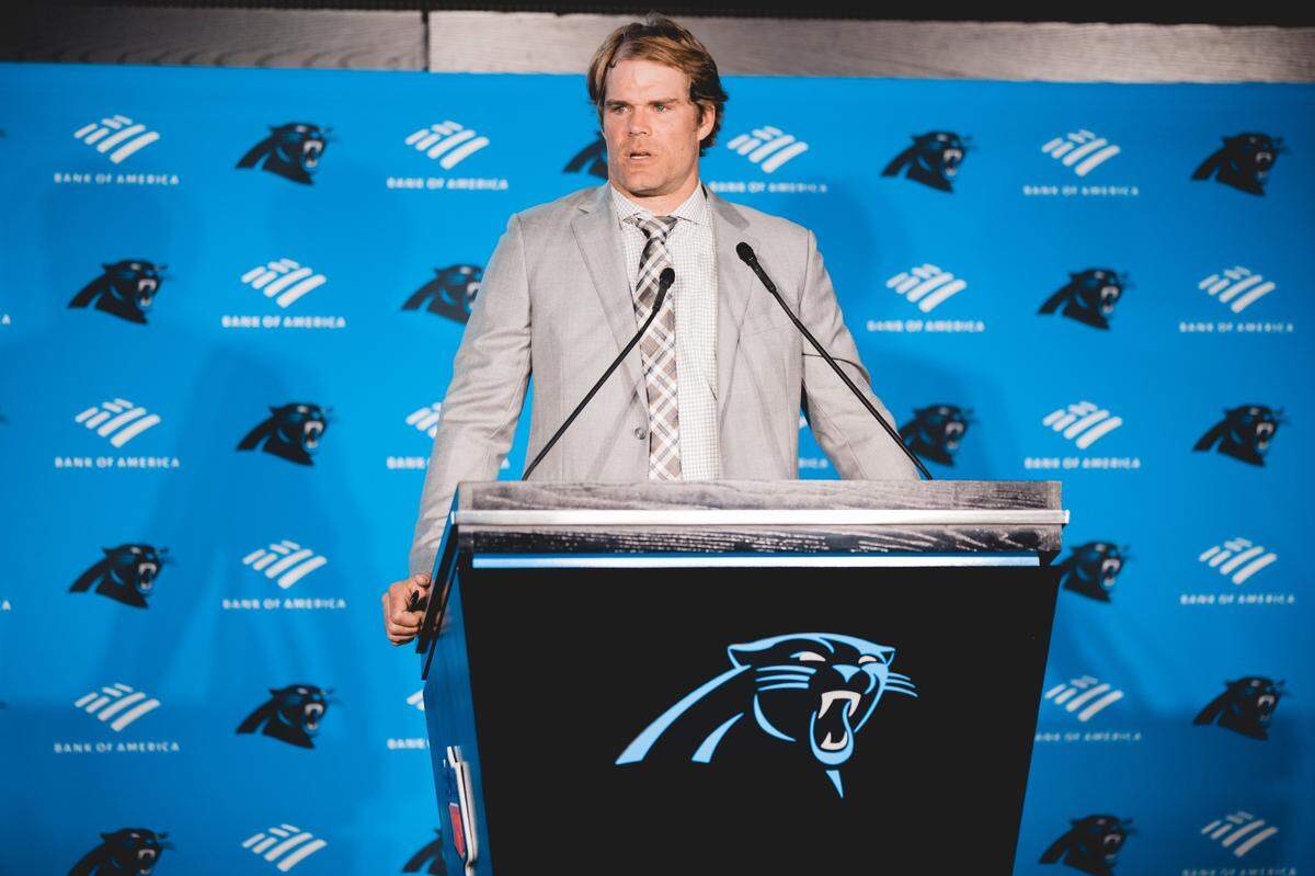 Greg Olsen speaking at his Carolina Panthers retirement ceremony in March. He was signed to a one-day contract so he could officially retire as a Panther, sharing that day with former Carolina linebacker Thomas Davis.