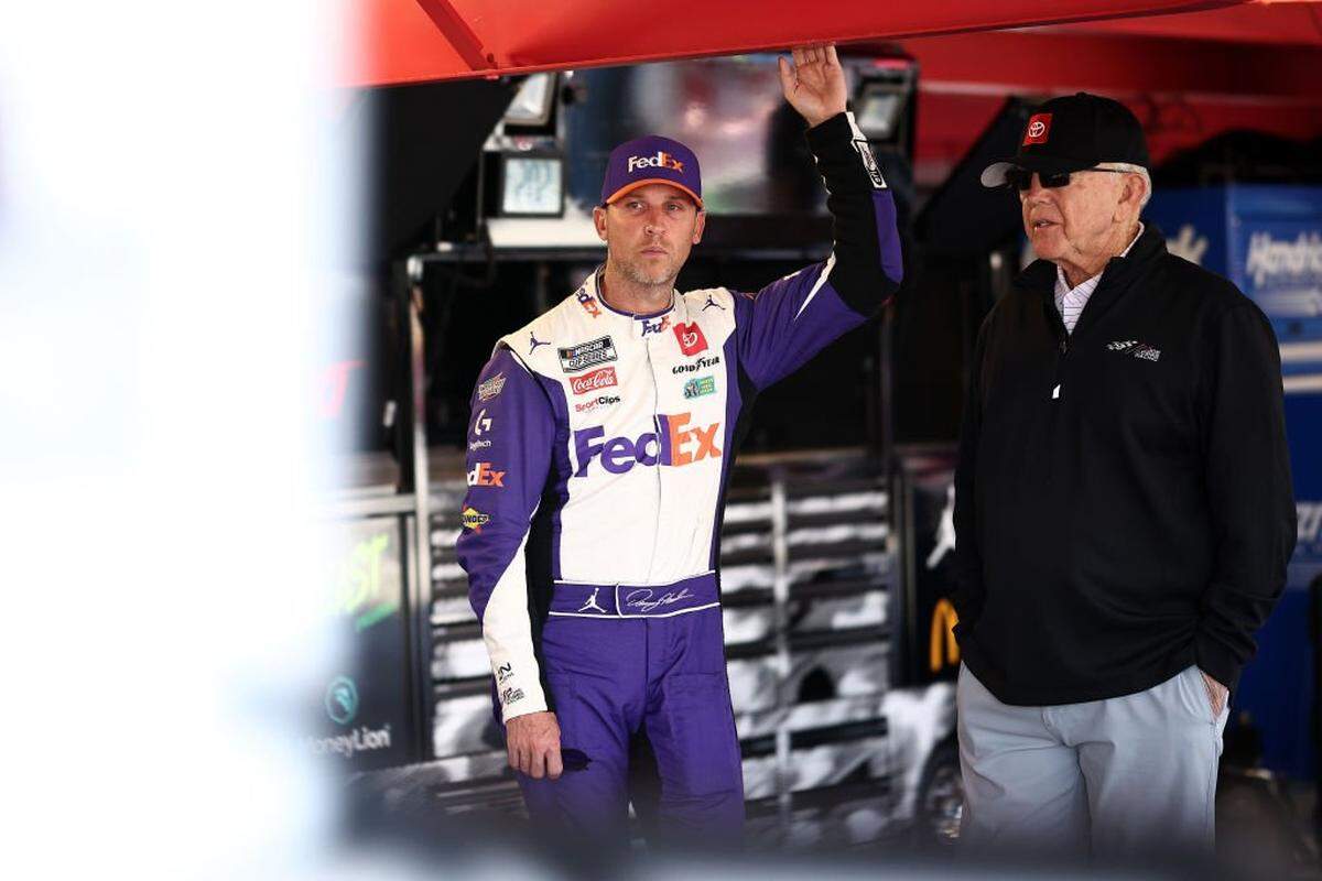Denny Hamlin, driver of the No. 11 FedEx One Rate Toyota, and JGR team owner and NASCAR Hall of Famer Joe Gibbs talk in the garage area after an on-track incident during practice for the NASCAR Cup Series Xfinity 500 on Nov. 2, 2024, at Martinsville Speedway.