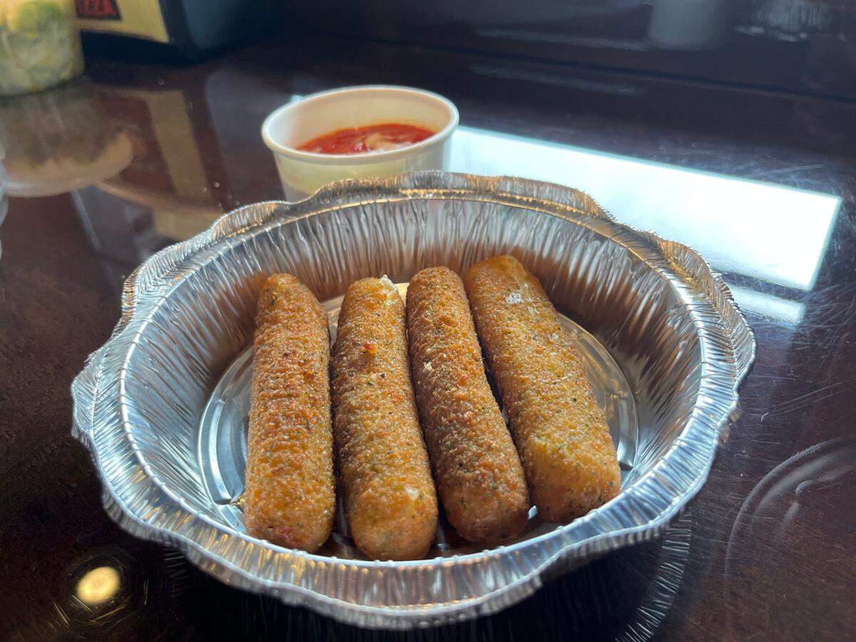 Zepeddie’s crispy mozzarella sticks come with a side of red sauce.