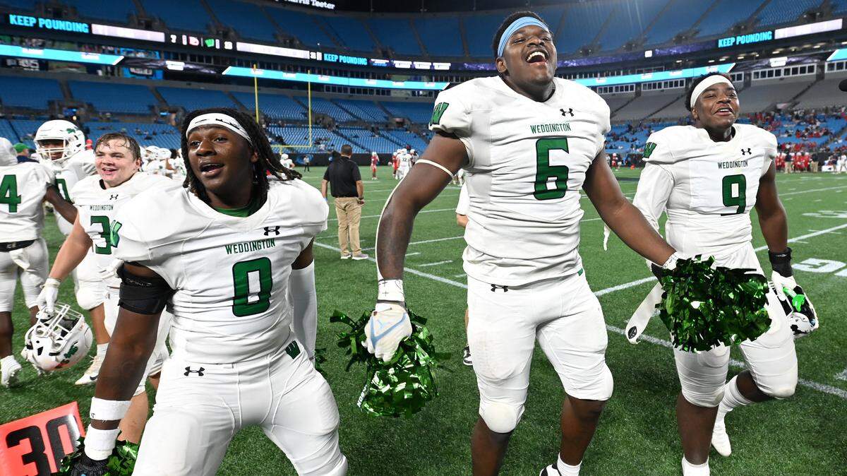 Weddington linebacker TJ Davis, left, defensive lineman Aiden Harris, center and defensive lineman Trajen Odom, right, celebrate their team’s 13-7 victory over Providence Day on Thursday, August 22, 2024 at Bank of America Stadium in Charlotte, NC. Both teams competed in the Keep Pounding High School Classic.