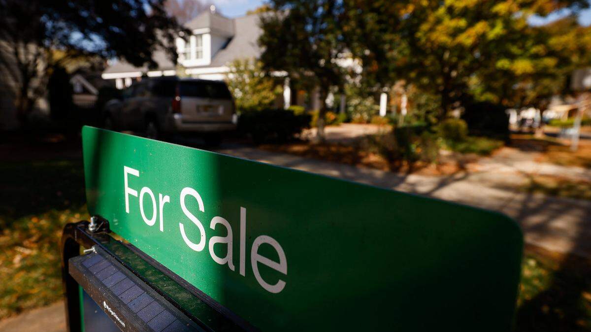 A for sale sign sits in front of a house on Circle Avenue in Charlotte, N.C., Friday, Nov. 4, 2022.