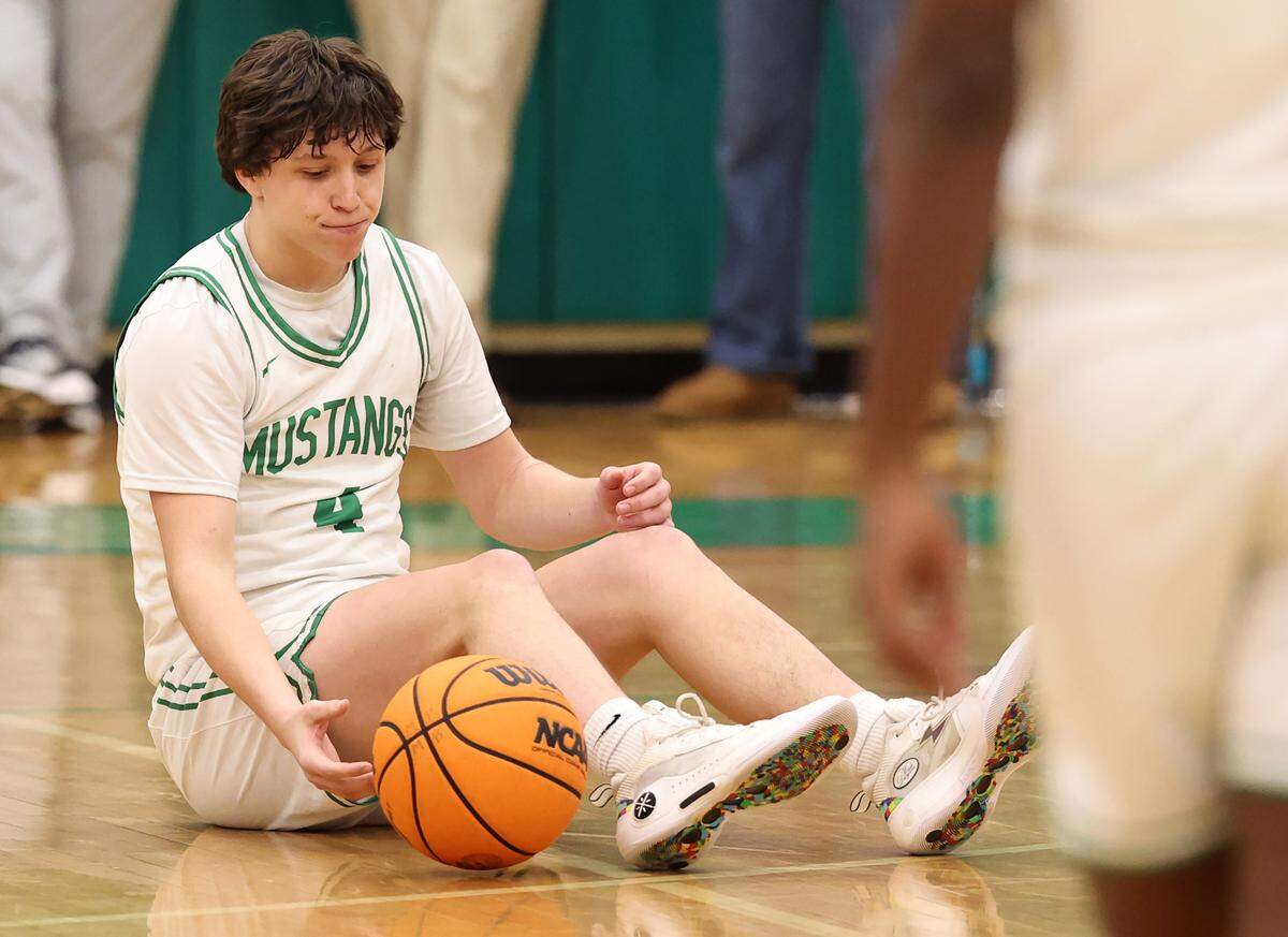 Myers Park’s Bram Early sits on the floor following a play during the closing moments of action against South Meck on Friday, January 17, 2025 at Myers Park High in Charlotte, NC.