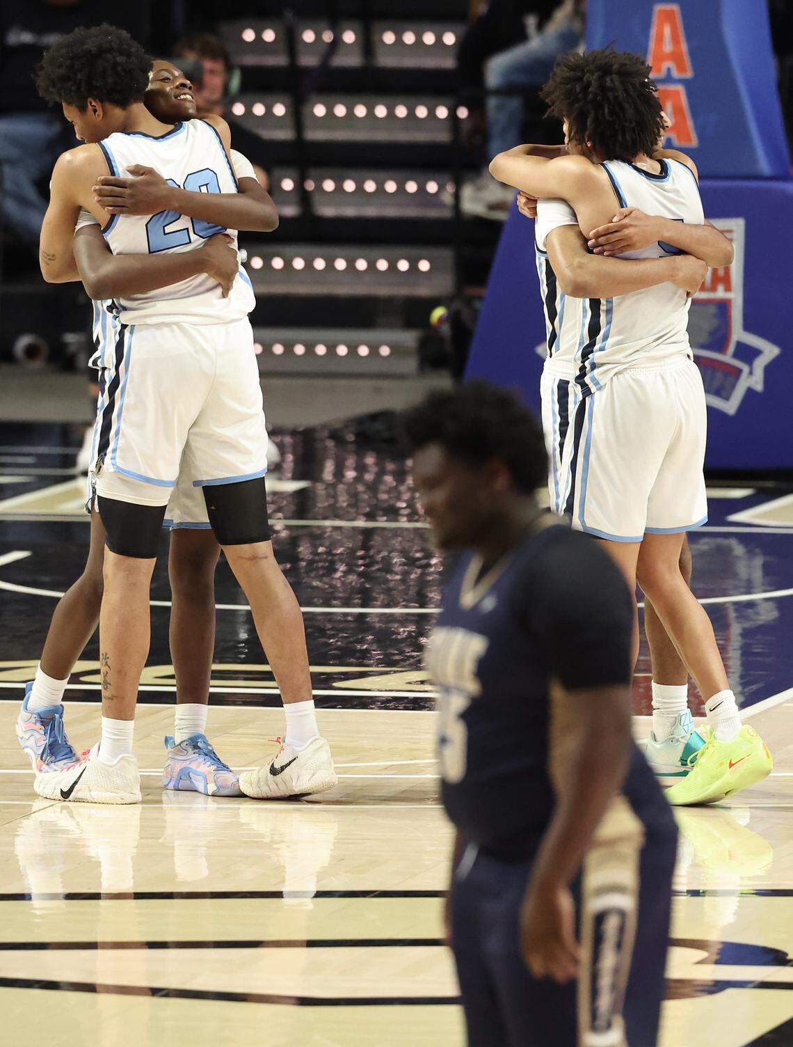 Members of the Hunter Huss boys basketball team begin to celebrate their 103-69 victory over Fike in the NCHSAA 5A boys championship game on Saturday, March 14, 2026 at Lawrence Joel Veterans Memorial Coliseum in Winston-Salem, NC. 