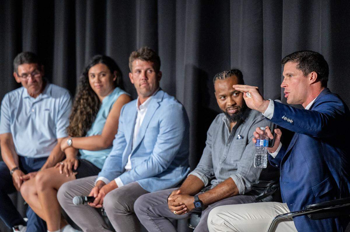 Linebacker Luke Kuechly (far right) makes a point as the rest of the panelists listen following the premiere of the “Super Men” documentary on July 24, 2025, at the Independence Picture House. From left, with their titles from the 2015 season that the film documents: Head coach Ron Rivera, social media coordinator Courtney Rivera, long snapper J.J. Jansen, cornerback Josh Norman and Kuechly.