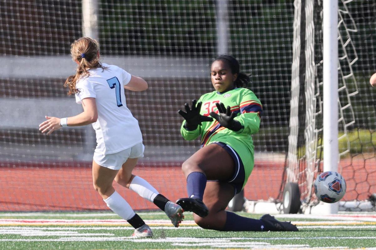 Latin forward Ella Smith (7) scores against Providence Day goalkeeper Chandler Brooks in the first half in Charlotte, N.C., Saturday, May 15, 2021.