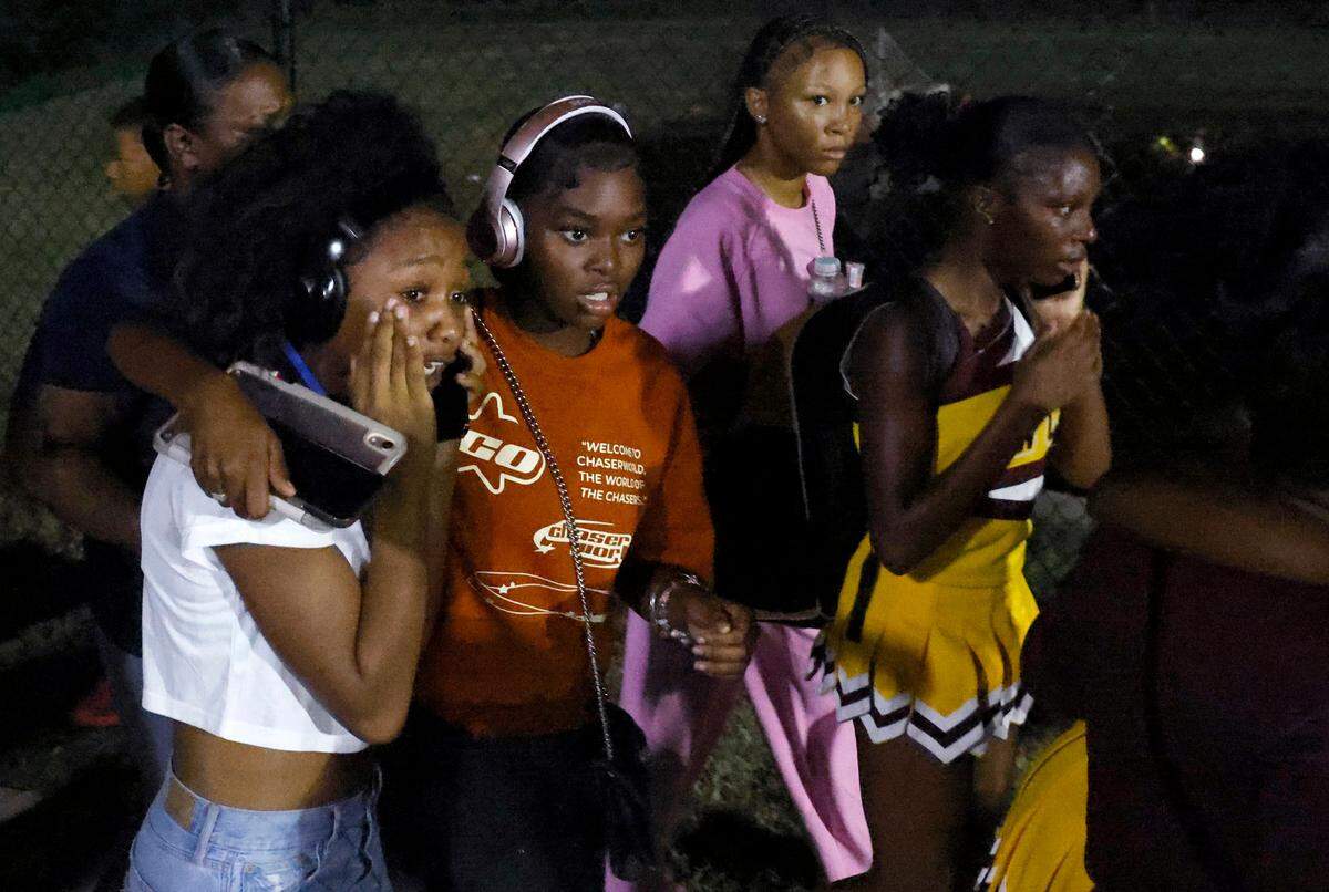 Fans walk cautiously back to the stands following a chaotic scene of players and fans scrambling for safety during a disturbance at the team’s game with West Charlotte on Friday, September 20, 2024.