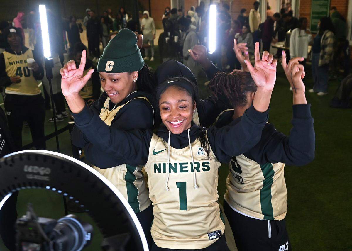Charlotte 49ers women’s basketball player Jordan Peete, center, strikes a pose with her teammates as they enjoy the QC 360 video booth during fan fest at the University Recreation Center on the campus of UNC Charlotte on Thursday, October 17, 2024.