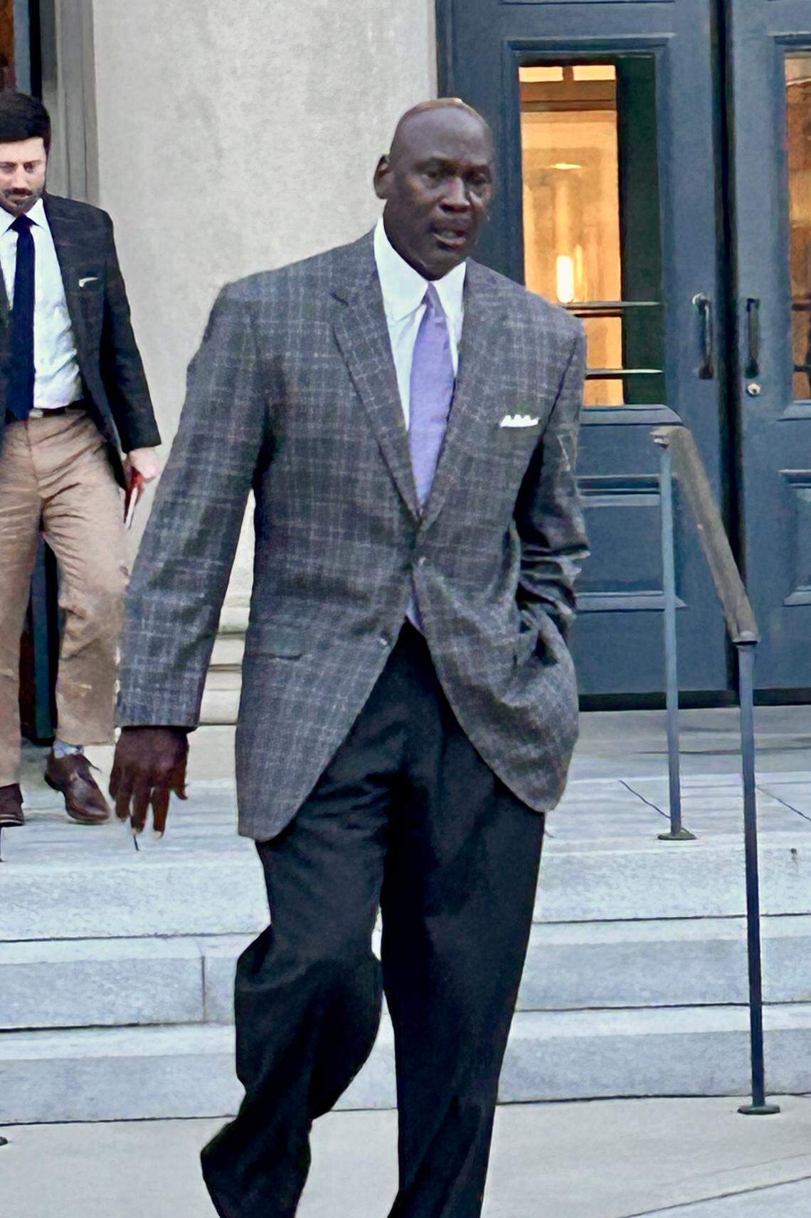 Michael Jordan, the basketball star turned NASCAR owner, leaves a Charlotte courtroom Wednesday, Dec. 3, 2025, during the trial in which Jordan and Denny Hamlin have filed a lawsuit accusing NASCAR of being an unlawful monopoly.