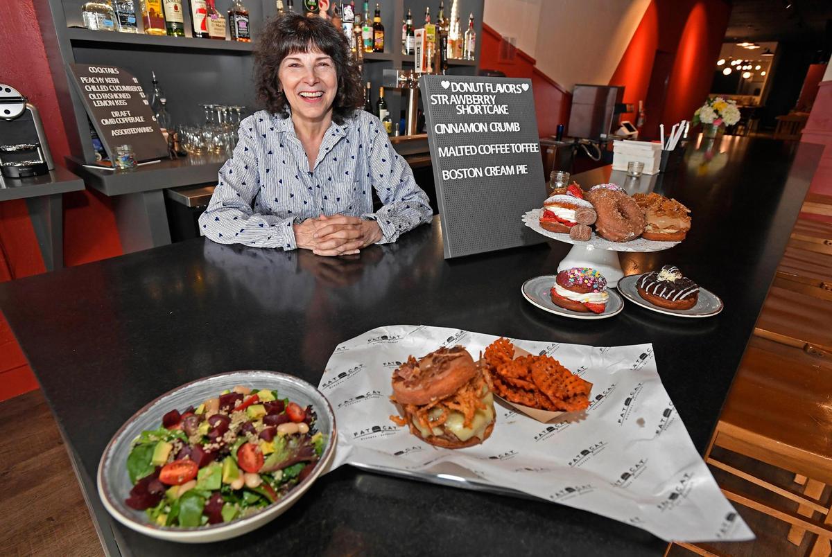 Fat Cat Burgers + Bakeshop owner Fran Scibelli shows some of the meals and bakery treats Thursday that will be available at her new restaurant when it opens April 5 in the former Fran’s Filling Station site.