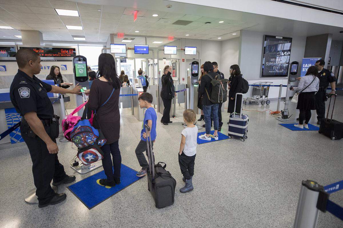 U.S. Customs and Border Protection, Office of Field Operations, officers take biometric photos of passengers prior to boarding a flight at Houston International Airport on February 12, 2018. Photographer: Donna Burton