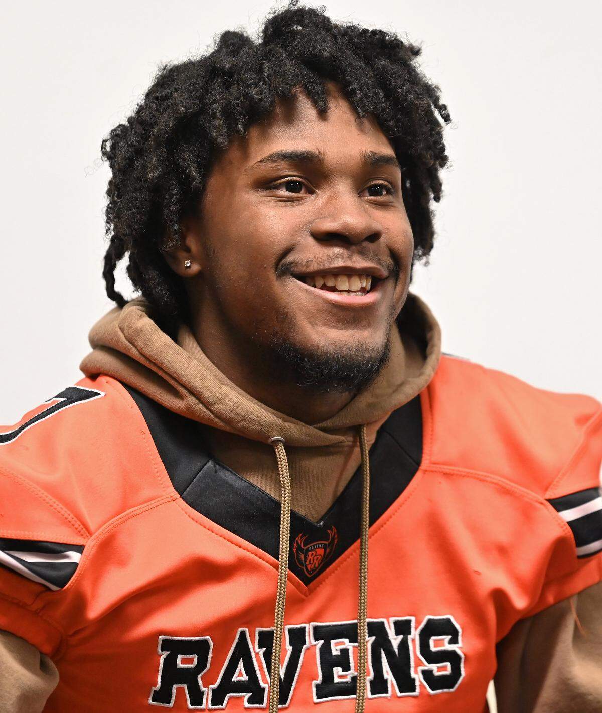 Rocky River defensive back Elijah Phillips smiles as he discusses moving into head coach Kenneth McClamrock's home during this past football season on Wednesday, April 22, 2026. Phillips was without housing.